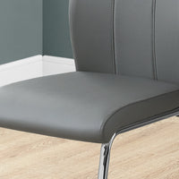 Two 77.5" Grey Leather Look, Chrome Metal, and Foam Dining Chairs